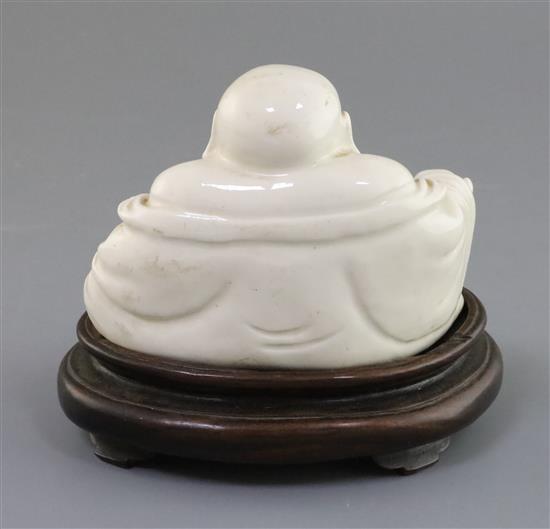 A Chinese blanc-de-chine figure of Budai, 19th century, H. 14cm including hongmu stand